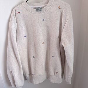 Taylor Swift embroidered sweatshirt has cute emblems from different eras/albums